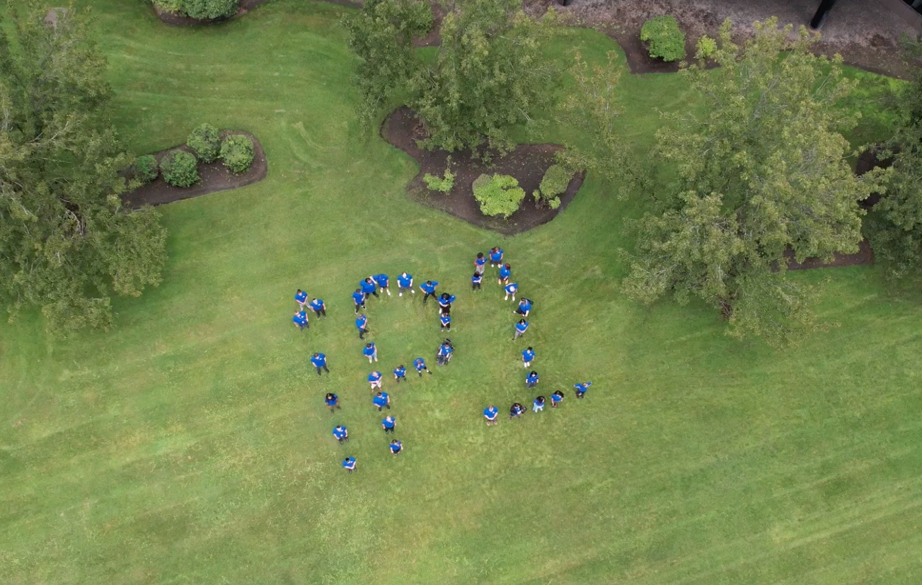 iPostal1 team posing to create a giant iP1